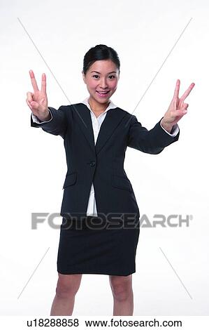 Stock Photo - Young woman in business suit, raising four fingers. Fotosearch