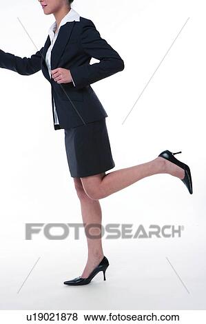 Young woman in business suit, running, side view, low section View Large Photo Image Stock Photo - Young woman in business suit, running, side view, low section. Fotosearch