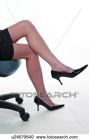 Young woman in business suit, sitting, side view, low section View Large Photo Image Stock Image - Young woman in business suit, sitting, side view, low section. Fotosearch