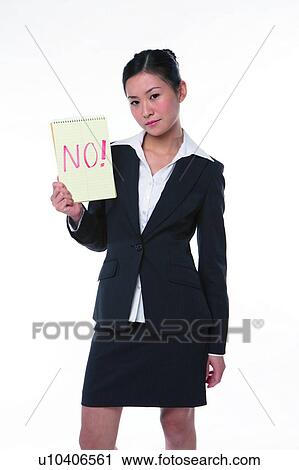 Stock Image - Young woman in business suit, standing, holding an notebook with "No" marked on. Fotosearch