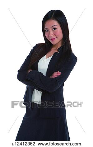 Stock Image - Young woman in business suit, standing in confidence, side view. Fotosearch