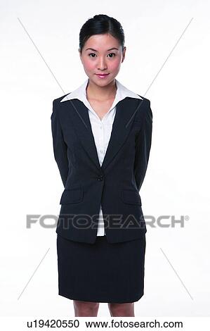 Young woman in business suit, standing formally View Large Photo Image Stock Image - Young woman in business suit, standing formally. Fotosearch