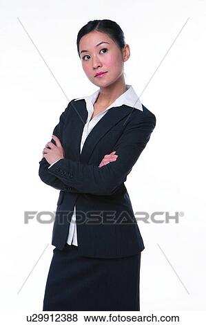 Young woman in business suit, standing with challenging attitude View Large Photo Image Stock Photo - Young woman in business suit, standing with challenging attitude. Fotosearch