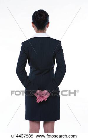 Young woman in business suit, standing with hands on waist, rear view, full length View Large Photo Image Stock Photography - Young woman in business suit, standing with hands on waist, rear view, full length. Fotosearch