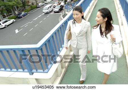 Woman who crosses a pedestrian overpass View Large Photo Image Stock Photography - Woman who crosses a pedestrian overpass. Fotosearch