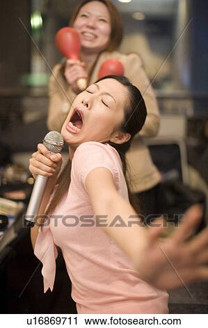 Stock Image - Woman who does karaoke. Fotosearch