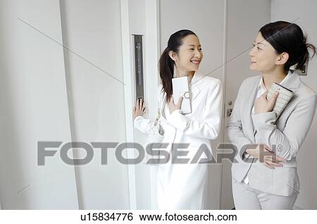 Stock Photograph - Woman who waits for the elevator. Fotosearch