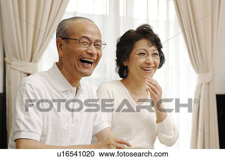 Stock Image - Chatting senior couple. Fotosearch