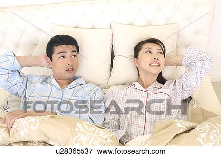 Couple lying down View Large Photo Image Stock Photo - Couple lying down. Fotosearch