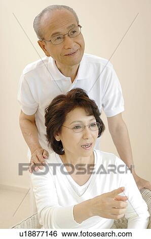 Stock Photograph - Cuddling up elderly couple. Fotosearch