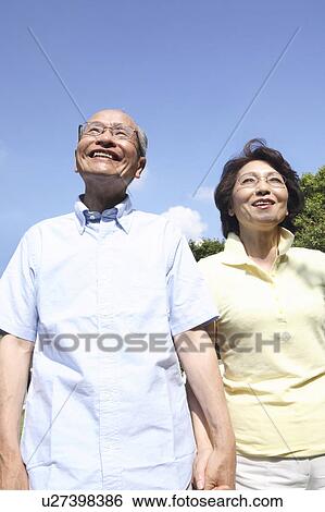 Stock Photograph - Old couple connecting a hand. Fotosearch