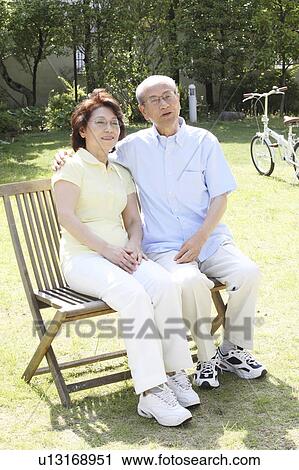 Old couple sitting down on a chair View Large Photo Image Stock Image - Old couple sitting down on a chair. Fotosearch