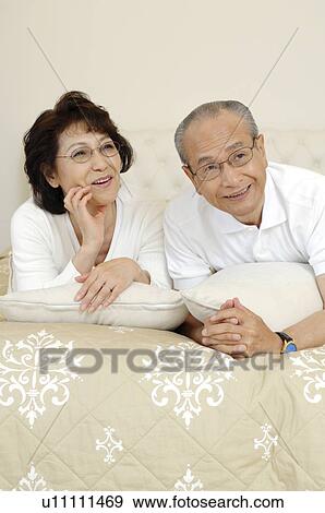 Stock Photo - Relaxing elderly couple. Fotosearch