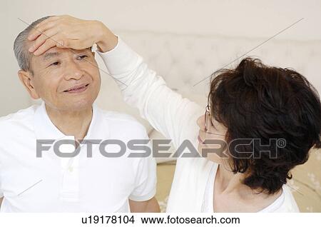 Wife who measures heat View Large Photo Image Picture - Wife who measures heat. Fotosearch