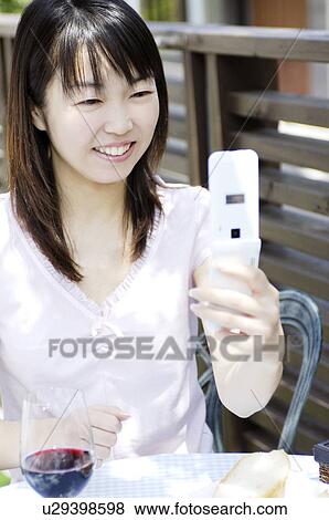 Stock Photo - Woman seeing a cell phone. Fotosearch