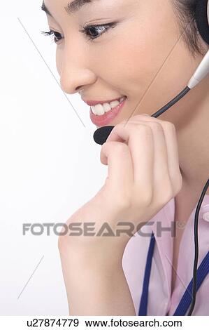 Stock Photo - Business lady talking in headset. Fotosearch