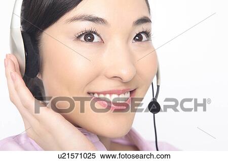 Stock Photography - Business lady talking in headset. Fotosearch