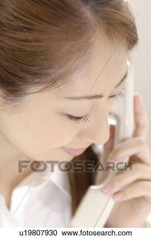 Stock Image - Business lady who is on the phone. Fotosearch