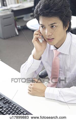 Businessman speaking with a cell phone View Large Photo Image Stock Image - Businessman speaking with a cell phone. Fotosearch