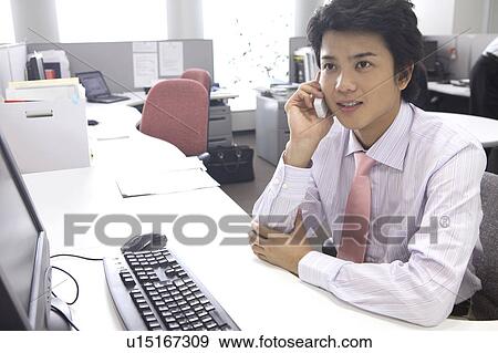 Businessman speaking with a cell phone View Large Photo Image Stock Photo - Businessman speaking with a cell phone. Fotosearch