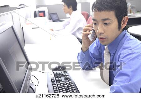Stock Photo - Businessman speaking with a cell phone. Fotosearch
