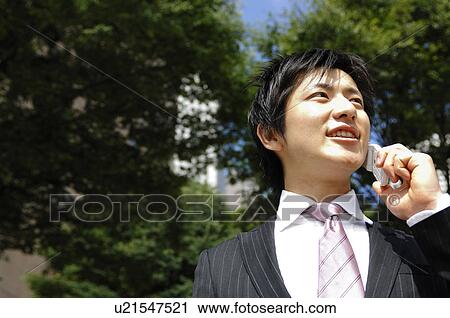 Stock Image - Businessman talking with a cell phone. Fotosearch