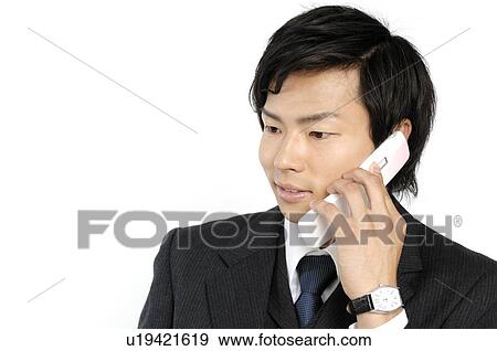 Stock Photo - Businessman talking with a cell phone. Fotosearch