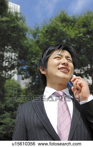 Stock Photograph - Businessman talking with a cell phone. Fotosearch