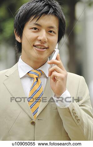 Stock Photography - Businessman talking with a cell phone. Fotosearch