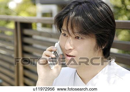 Stock Photograph - Man talking with a cell phone. Fotosearch