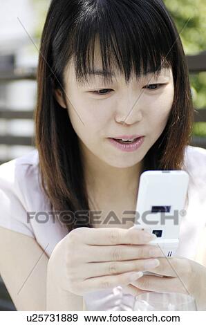 Woman who does a cell phone View Large Photo Image Stock Photo - Woman who does a cell phone. Fotosearch