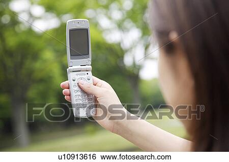 Woman who takes a photograph by cell phone View Large Photo Image Stock Photograph - Woman who takes a photograph by cell phone. Fotosearch