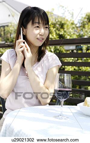 Stock Image - Womantalking with a cell phone. Fotosearch