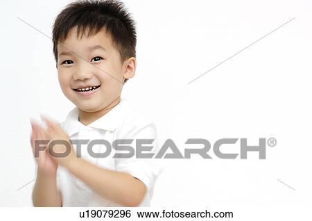 Stock Photograph - Boy claping a hand. Fotosearch
