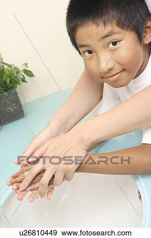 Stock Photo - Boy washing a hand. Fotosearch