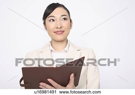 Stock Image - Business lady having a notebook. Fotosearch