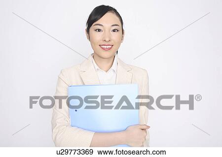 Business lady holding a file with both hands View Large Photo Image Stock Photo - Business lady holding a file with both hands. Fotosearch