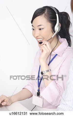 Business lady talking in headset View Large Photo Image Stock Image - Business lady talking in headset. Fotosearch