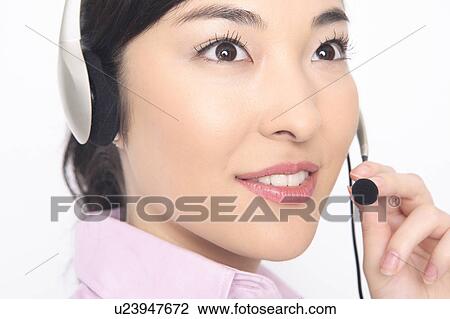 Business lady talking in headset View Large Photo Image Stock Image - Business lady talking in headset. Fotosearch