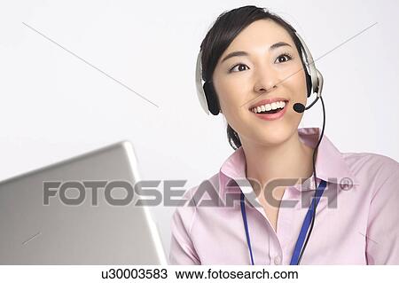 Business lady talking in headset View Large Photo Image Stock Image - Business lady talking in headset. Fotosearch