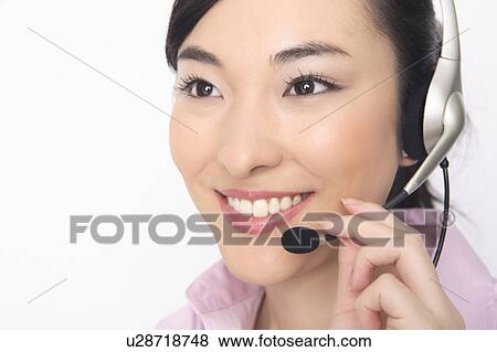 Stock Photo - Business lady talking in headset. Fotosearch