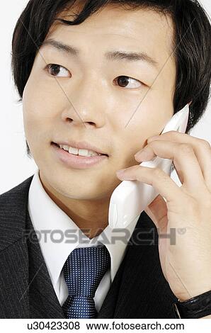 Businessman talking with a cell phone View Large Photo Image Stock Photo - Businessman talking with a cell phone. Fotosearch