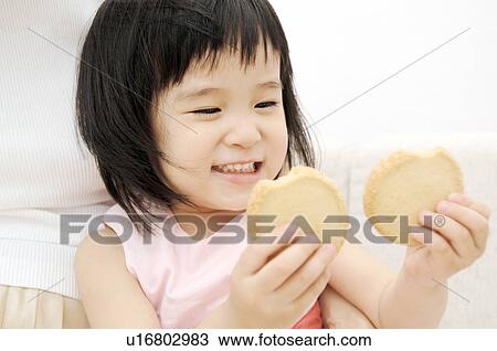 Girl having cookies View Large Photo Image Stock Image - Girl having cookies. Fotosearch