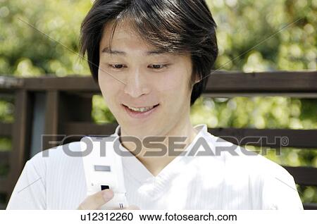 Stock Image - Man seeing cell phone. Fotosearch