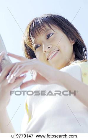 Woman calling by a cell phone View Large Photo Image Stock Photo - Woman calling by a cell phone. Fotosearch