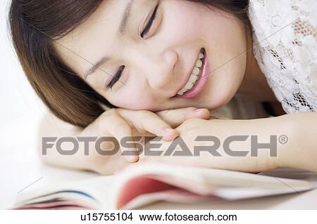 Picture - Woman reading a book. Fotosearch