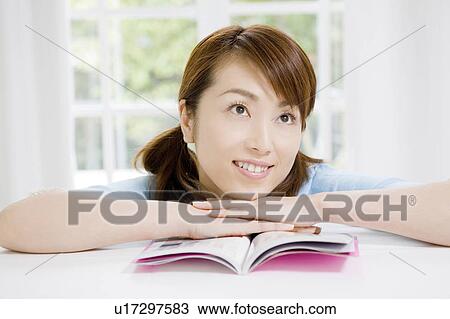 Stock Image - Woman reading a book. Fotosearch