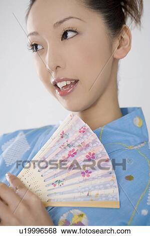 Stock Photo - Japanese folding fan and yukata woman. Fotosearch