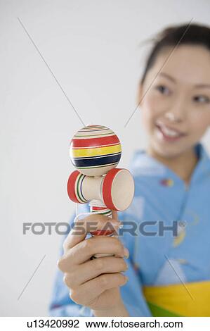 Stock Image - Yukata woman who does a cup-and-ball. Fotosearch