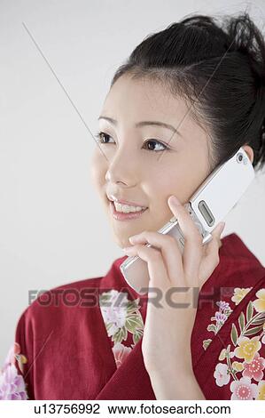 Stock Image - Yukata woman who is on the phone. Fotosearch